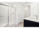 Bathroom with a glass-enclosed shower, double sinks, and a door leading to another room at 1117 Stubble Run, Danville, IN 46122