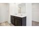 Bathroom featuring a dual sink vanity with modern fixtures and a view of a closet at 1117 Stubble Run, Danville, IN 46122