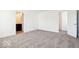 A bedroom with carpet flooring leads to the bathroom and the hallway at 1117 Stubble Run, Danville, IN 46122
