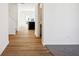 Bright entryway with wood-look flooring, white walls, and an open floor plan leading to the kitchen and living spaces at 1117 Stubble Run, Danville, IN 46122