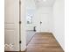View of the bright foyer showcasing beautiful hardwood flooring and a glimpse into the carpeted living area at 1117 Stubble Run, Danville, IN 46122