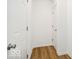 A simple hallway featuring two white doors and light wood-look flooring at 1117 Stubble Run, Danville, IN 46122