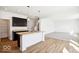 A kitchen features a center island, stainless steel sink, and dark wood cabinets next to the living area at 1117 Stubble Run, Danville, IN 46122