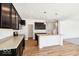 A kitchen with dark wood cabinets, stainless appliances, and a center island on a wood floor at 1117 Stubble Run, Danville, IN 46122