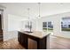 A modern kitchen island with stainless steel sink and dishwasher in an open floor plan at 1117 Stubble Run, Danville, IN 46122