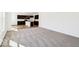 Open concept living room with plush carpeting that flows into a modern kitchen with dark cabinetry and an island at 1117 Stubble Run, Danville, IN 46122