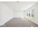 Spacious living room with plush carpet, large windows, and natural light in a new construction home at 1117 Stubble Run, Danville, IN 46122
