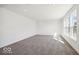Bright living room with plush carpet, a neutral palette, and large windows in a new construction home at 1117 Stubble Run, Danville, IN 46122