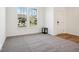 Bright living room with windows, neutral carpet, and white walls, offering a minimalist and clean aesthetic at 1117 Stubble Run, Danville, IN 46122