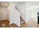 Newly constructed staircase with carpeted steps, white walls, and wood-look floors in a bright, modern home at 1117 Stubble Run, Danville, IN 46122