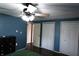 Cozy bedroom with ceiling fan, featuring dark wood floors and two closets at 1255 Easy St, Greenwood, IN 46142