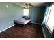 Cozy bedroom featuring hardwood floors, a ceiling fan, and a window at 1255 Easy St, Greenwood, IN 46142