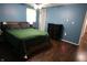Well-lit bedroom with hardwood floors, a comfortable bed, and ample space for relaxation at 1255 Easy St, Greenwood, IN 46142
