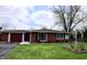 Charming single-story brick home with an attached garage and a well-maintained front lawn at 1255 Easy St, Greenwood, IN 46142
