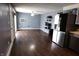 Open-concept living room featuring sleek hardwood floors and modern appliances at 1255 Easy St, Greenwood, IN 46142