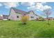 The backyard features a well-maintained lawn and mature landscaping at 13494 Moorcroft Dr, Fishers, IN 46037