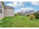 A spacious backyard features a well-maintained lawn, shrubs, and mature trees at 13494 Moorcroft Dr, Fishers, IN 46037
