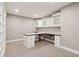 Finished basement office boasts white custom cabinets, a desk, and built-in shelves at 13494 Moorcroft Dr, Fishers, IN 46037