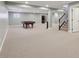 Spacious finished basement featuring a pool table and staircase leading to the upper level at 13494 Moorcroft Dr, Fishers, IN 46037