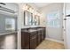 Bathroom featuring double sink vanity, a large window, and a view through the doorway at 13494 Moorcroft Dr, Fishers, IN 46037