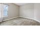 An empty bedroom featuring neutral-colored walls, carpet flooring, and a window with natural light at 13494 Moorcroft Dr, Fishers, IN 46037