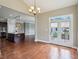 Dining room with hardwood floors, chandelier and a view into the kitchen at 13494 Moorcroft Dr, Fishers, IN 46037