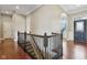 Home interior foyer featuring dark wood floors, iron railing, and arched doorway at 13494 Moorcroft Dr, Fishers, IN 46037