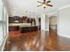 Kitchen with dark wood cabinetry, granite countertops, stainless appliances, and hardwood floors at 13494 Moorcroft Dr, Fishers, IN 46037