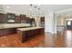 Kitchen featuring granite countertops, stainless appliances, dark cabinets and hardwood floors at 13494 Moorcroft Dr, Fishers, IN 46037