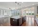 Kitchen with granite counters, stainless appliances, and a view into the adjacent living room at 13494 Moorcroft Dr, Fishers, IN 46037