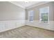 Living room with carpeted floors, decorative molding, and two windows offering a view at 13494 Moorcroft Dr, Fishers, IN 46037