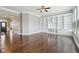 Open-concept living room with hardwood floors and built-in shelving at 13494 Moorcroft Dr, Fishers, IN 46037