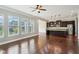 Living room view into the kitchen with stainless appliances, granite counters, and dark cabinetry at 13494 Moorcroft Dr, Fishers, IN 46037