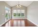 Bright sunroom with hardwood floors, large windows and a door to the backyard at 13494 Moorcroft Dr, Fishers, IN 46037