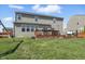 Spacious backyard featuring a well-maintained lawn and a multi-level wooden deck with ample seating at 1575 Oakvista Dr, Greenwood, IN 46143