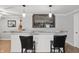 Finished basement bar area with marble countertop, storage, and two stools at 1575 Oakvista Dr, Greenwood, IN 46143