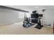 Finished basement with home gym and entertainment area with two televisions at 1575 Oakvista Dr, Greenwood, IN 46143