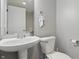 Half bathroom with a modern sink and a toilet at 1575 Oakvista Dr, Greenwood, IN 46143