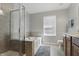 Bathroom featuring separate shower, soaking tub, double vanity and tile floors at 1575 Oakvista Dr, Greenwood, IN 46143