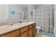 Neutral colored bathroom with double vanity, and shower and tub combo at 1575 Oakvista Dr, Greenwood, IN 46143