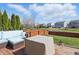 Backyard deck featuring comfortable seating, a pond view, and established landscaping, perfect for relaxation at 1575 Oakvista Dr, Greenwood, IN 46143