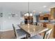 Dining area featuring a wooden table with chairs, adjacent to the kitchen with warm wooden cabinets at 1575 Oakvista Dr, Greenwood, IN 46143