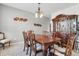 Elegant dining room with a large wooden table, chairs, and a decorative hutch at 1575 Oakvista Dr, Greenwood, IN 46143