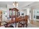 Charming dining area with wood table and chairs and view to living area at 1575 Oakvista Dr, Greenwood, IN 46143
