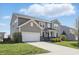 Charming two-story home featuring manicured landscaping and a welcoming entrance at 1575 Oakvista Dr, Greenwood, IN 46143