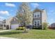 Charming home with a well-manicured front lawn, mature flowering tree, and inviting curb appeal at 1575 Oakvista Dr, Greenwood, IN 46143