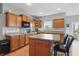 Well-lit kitchen featuring wood cabinets, granite countertops, stainless appliances, and an island at 1575 Oakvista Dr, Greenwood, IN 46143