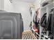 Well-lit laundry room featuring shelving and front load dryer at 1575 Oakvista Dr, Greenwood, IN 46143