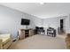 Upstairs living space boasts natural light, neutral colors, and tv at 1575 Oakvista Dr, Greenwood, IN 46143