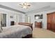 Large main bedroom featuring carpet, tray ceiling, dresser, and ceiling fan at 1575 Oakvista Dr, Greenwood, IN 46143